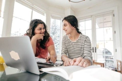 Parent helping child researching apprenticeships online